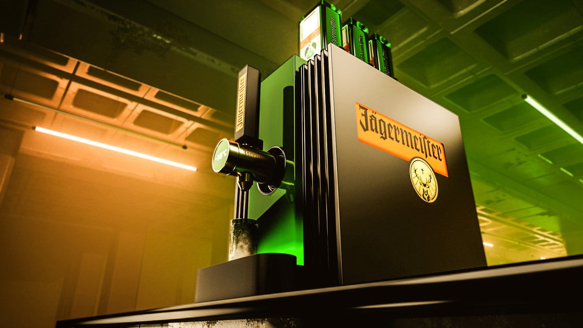 The 4th gen 3 bottle tap machine with a green illuminated background, shown in a dim industrial interior with green and orange lighting.