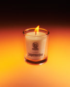 Jagermeister candle in a glass container with a dark background