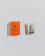 Jägermeister candle and orange box on a light gray background