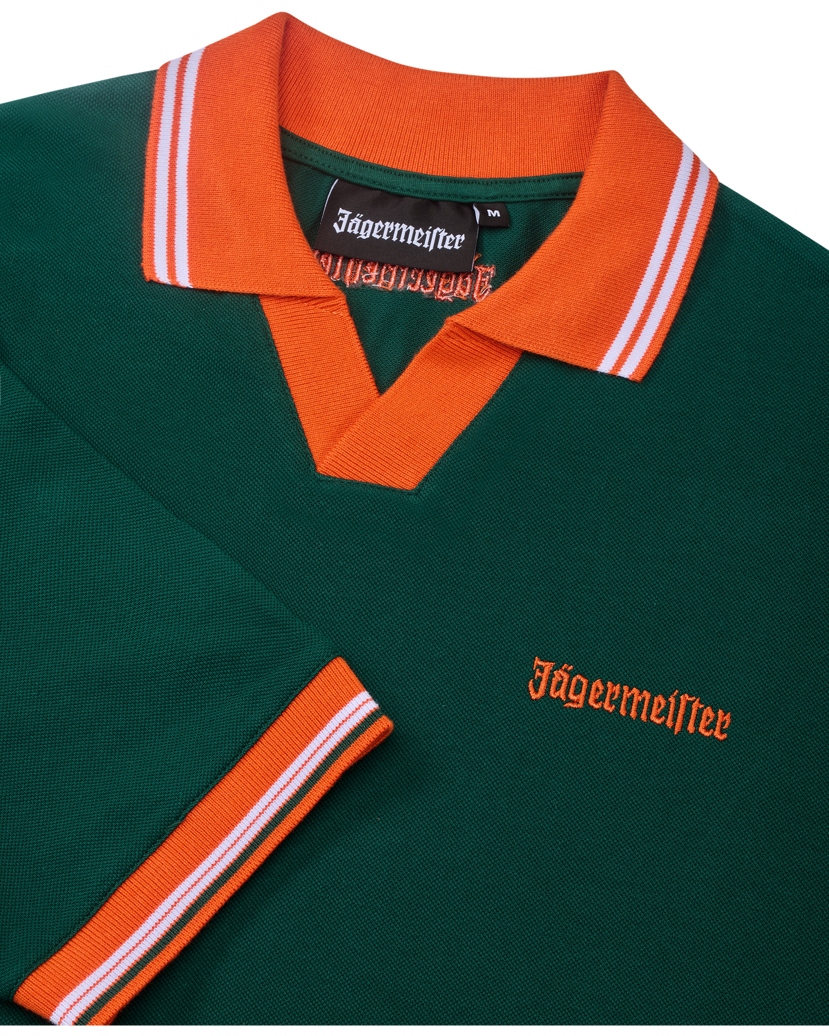 Green Jägermeister polo shirt with orange collar and trim featuring Jägermeister branding.