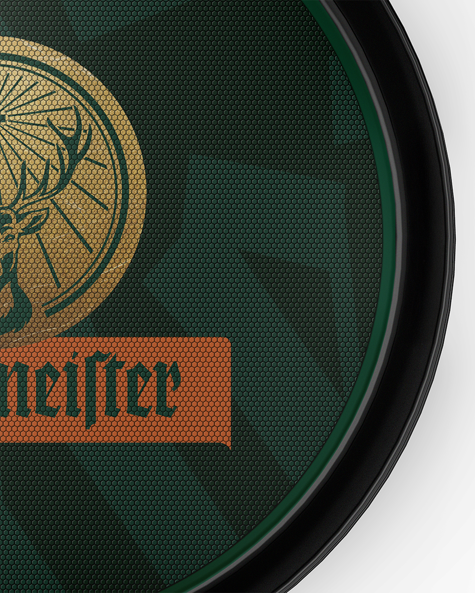 Close-up of a green Jägermeister serving tray with Jägermeister logo